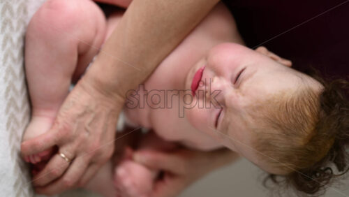 Caregiver doing mobility exercises with a baby