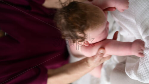 Caregiver doing mobility exercises with a baby