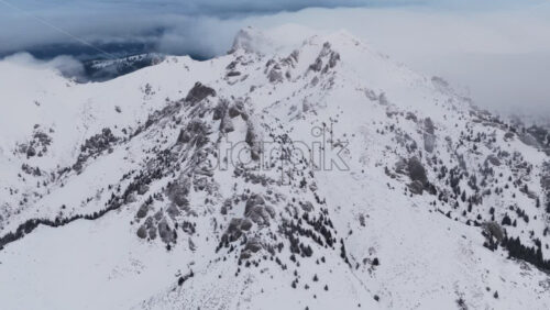 Panoramic aerial drone view of winter landscape in the mountains. Transylvania, Mount Ciucas in Romania