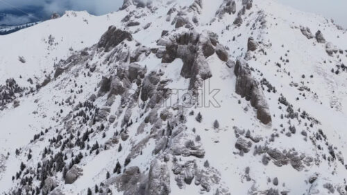 Panoramic aerial drone view of winter landscape in the mountains. Transylvania, Mount Ciucas in Romania