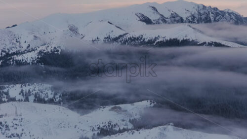 Panoramic aerial drone view of winter landscape in the mountains. Transylvania, Mount Ciucas in Romania