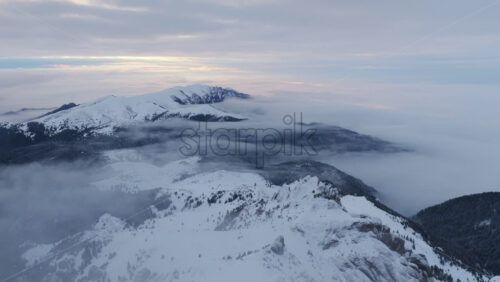 Panoramic aerial drone view of winter landscape in the mountains. Transylvania, Mount Ciucas in Romania