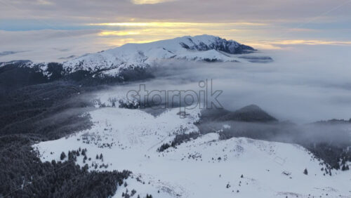 Panoramic aerial drone view of winter landscape in the mountains. Transylvania, Mount Ciucas in Romania