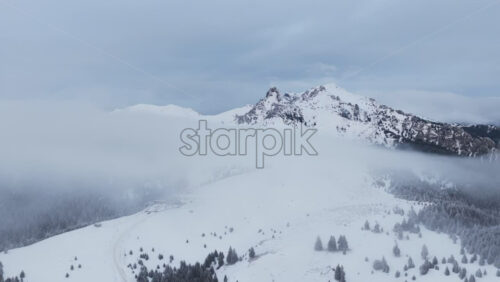Panoramic aerial drone view of winter landscape in the mountains. Transylvania, Mount Ciucas in Romania