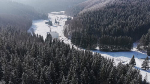 Panoramic aerial drone view of winter season with fir trees full of snow. Transylvania, Mount Ciucas in Romania, Carpathian mountains