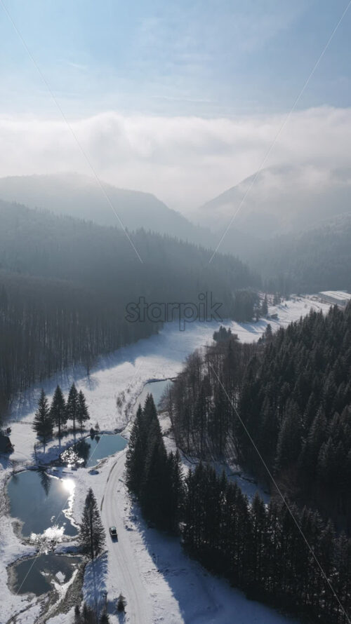 Panoramic aerial drone view of winter season with fir trees full of snow. Transylvania, Mount Ciucas in Romania, Carpathian mountains