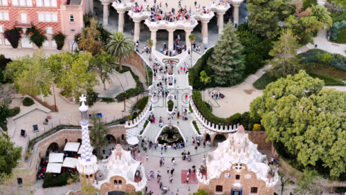 Aerial drone view of Park Guell. Antoni Gaudi architecture. A lot of greenery around, tourists Royalty Free Stock Video Footage - Starpik Stock