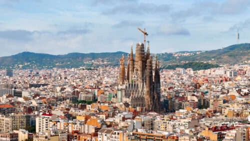 Aerial drone view of Sagrada Familia in city downtown. Famous residential districts around, greenery Royalty Free Stock Video Footage - Starpik Stock