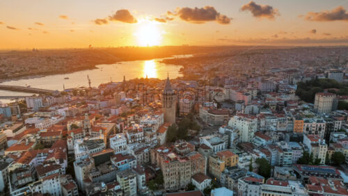 Premium stock video footage – Aerial drone hyperlapse view of Istanbul at sunset, Turkey. Multiple residential buildings around the Galata tower, nightlights, Golden Horn waterway on the background - Starpik Stock