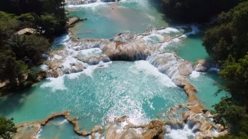 Video – Aerial drone view multiple turquoise waterfalls and natural pools surrounded by dense tropical forest at Agua Azul in southern Mexico - Starpik Stock