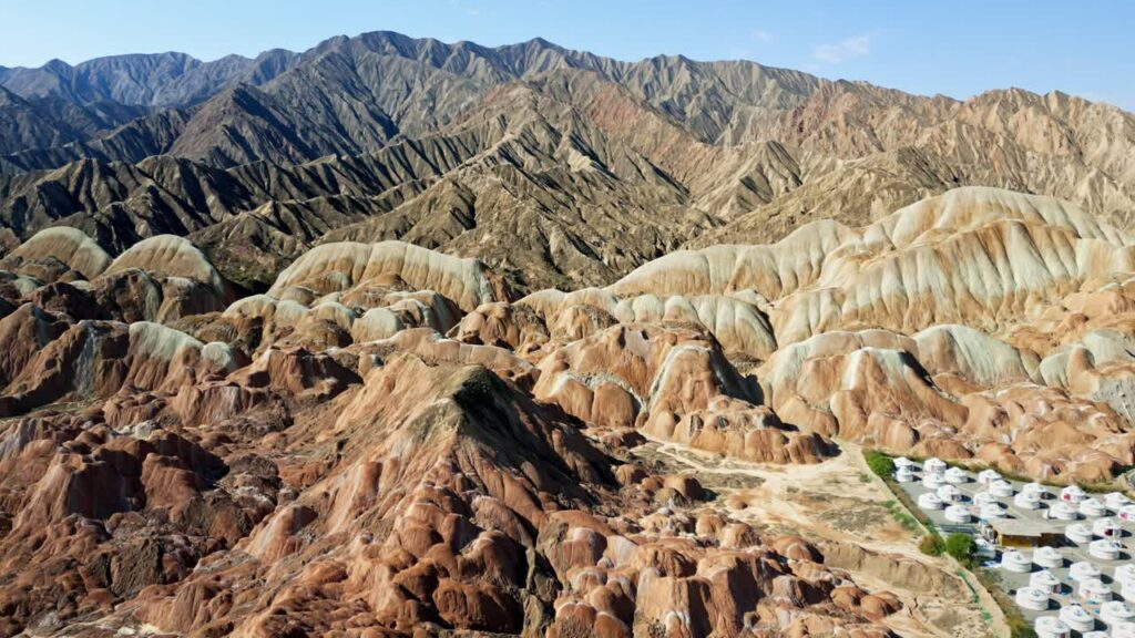 Video - Aerial drone view of Zhangye Danxia landforms with the Qilian Mountains in the background, Gansu Province, China