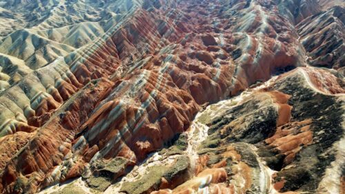 Video - Aerial drone view of eroded sandstone ridges in Zhangye Danxia National Geopark, Gansu, China