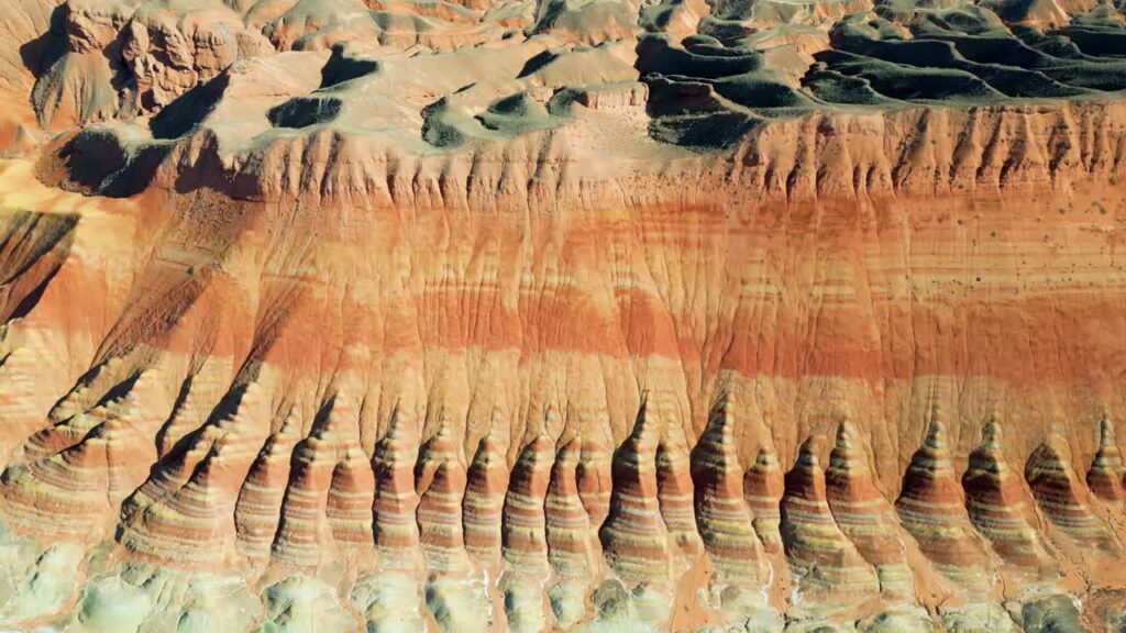 Video - Aerial drone view of layered sandstone cliff formations in Zhangye Danxia Geopark, Gansu Province, China