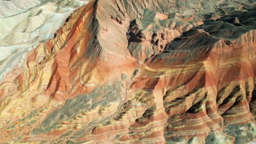 Video - Aerial drone view of layered sandstone cliff formations in Zhangye Danxia Geopark, Gansu Province, China
