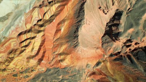Video - Aerial drone view of layered sandstone cliff formations in Zhangye Danxia Geopark, Gansu Province, China