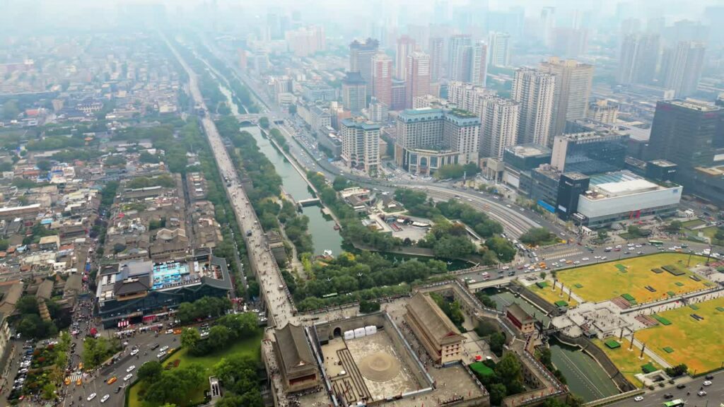 Video - Aerial drone view of central Xi'an, Shaanxi Province, China, featuring a long canal lined boulevard cutting through dense urban residential buildings