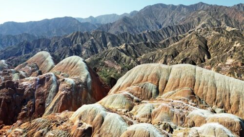 Video - Aerial drone view of the colorful layered rock formations of Zhangye Danxia National Geopark in Gansu Province