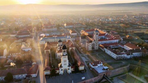Video - Aerial drone view of Alba Carolina Citadel in Alba Iulia, Romania. Star shaped Vauban fortress featuring historic cathedrals, fortified walls, and symmetrical urban layout