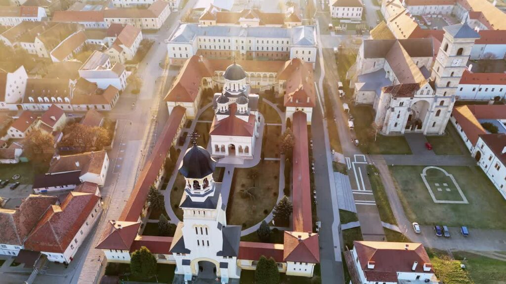 Video - Aerial drone view of Alba Carolina Citadel in Alba Iulia, Romania. Star shaped Vauban fortress featuring historic cathedrals, fortified walls, and symmetrical urban layout