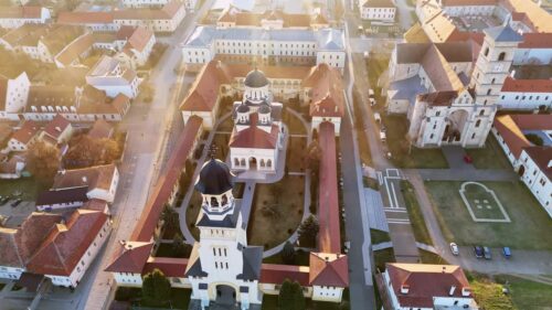 Video - Aerial drone view of Alba Carolina Citadel in Alba Iulia, Romania. Star shaped Vauban fortress featuring historic cathedrals, fortified walls, and symmetrical urban layout