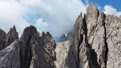 Video - Aerial drone view of limestone peaks of the Dolomites in northern Italy. Rugged mountain ridges and steep rock formations dominate the alpine landscape