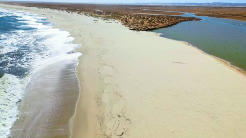 Video - Aerial drone view of a historic fortress built along dramatic mountain cliffs overlooking a canyon valley, highlighting ancient architecture and landscapes of the Mesopotamia region