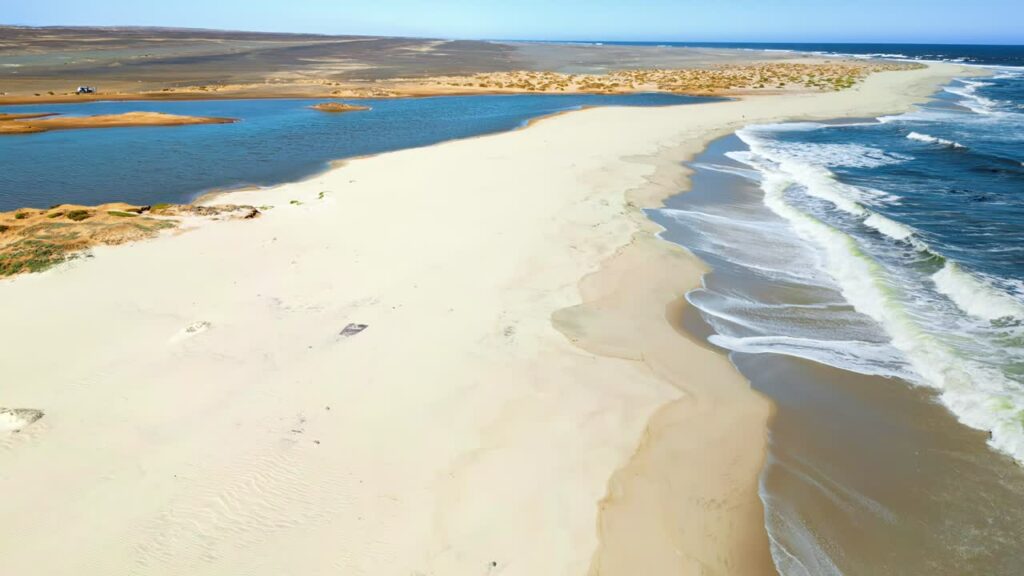 Video - Aerial drone view of a historic fortress built along dramatic mountain cliffs overlooking a canyon valley, highlighting ancient architecture and landscapes of the Mesopotamia region