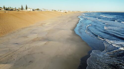 Video - Aerial drone view of a historic fortress built along dramatic mountain cliffs overlooking a canyon valley, highlighting ancient architecture and landscapes of the Mesopotamia region