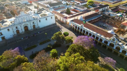 Video - Aerial drone view of Central Park and Antigua Cathedral surrounded by colonial buildings and colorful trees