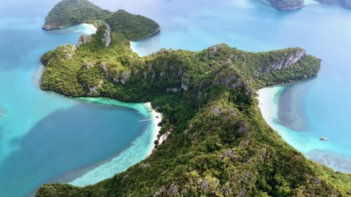 Video - Aerial drone view of a tropical island with white sand beaches and turquoise water bays in southern Thailand