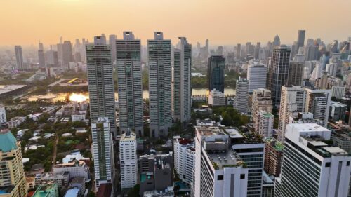 Video - Aerial drone view of Bangkok skyline at sunset with modern high rise buildings and golden evening light Bangkok, Thailand - June, 6, 2025: