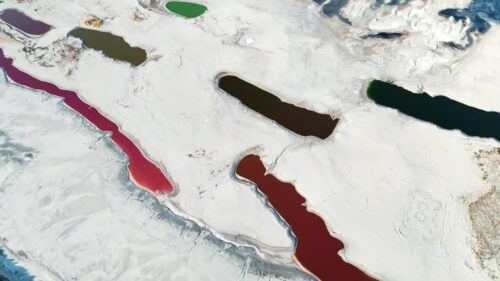 Video - Aerial drone view of colorful salt ponds and mineral pools in a dry desert landscape in Utah, United States