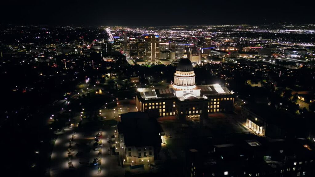 Video - Aerial drone view of the Utah State Capitol building illuminated with city lights of Salt Lake City in the background
