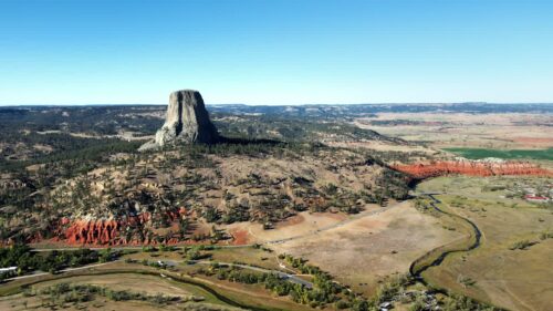 Video - Aerial drone view of Devils Tower National Monument rising dramatically above the surrounding landscape in Wyoming, US