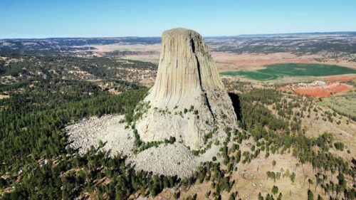 Video - Aerial drone view of Devils Tower National Monument rising dramatically above the surrounding landscape in Wyoming, US
