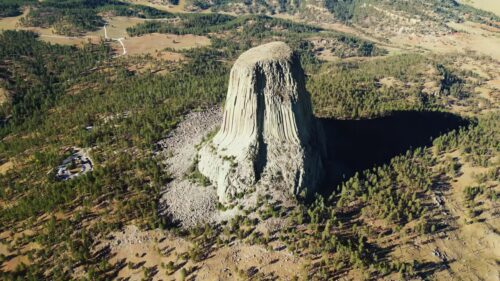 Video - Aerial drone view of Devils Tower National Monument rising dramatically above the surrounding landscape in Wyoming, US