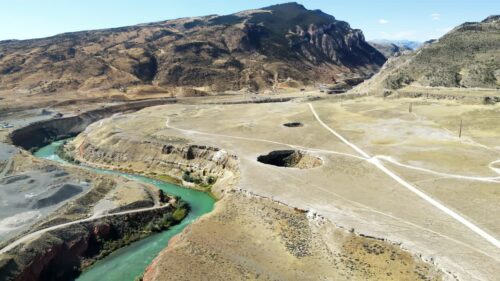 Video - Aerial drone view of winding turquoise river through rugged canyon landscape in Wyoming, USA