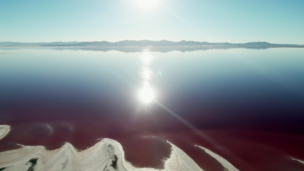 Video - Aerial drone view of colorful mineral salt ponds in the desert landscape of Utah, United States