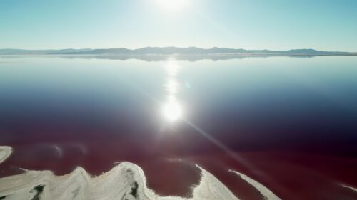 Video - Aerial drone view of colorful mineral salt ponds in the desert landscape of Utah, United States