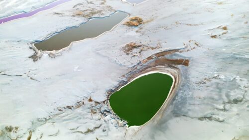 Video - Aerial drone view of colorful salt ponds and mineral pools in a dry desert landscape in Utah, United States
