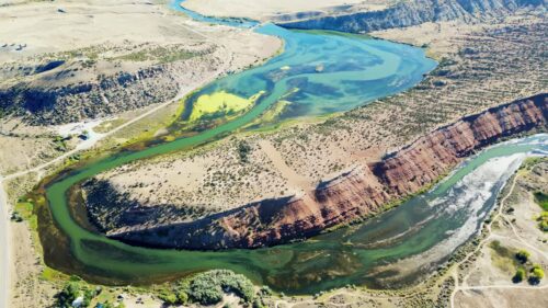Video - Aerial drone view of the San Juan River meanders in Goosenecks State Park, a famous geological formation where the river carved deep canyon bends into the desert landscape