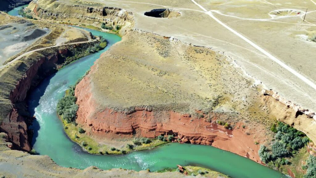 Video - Aerial drone view of the San Juan River flowing through desert cliffs and canyon landscape in the American Southwest near Goosenecks State Park
