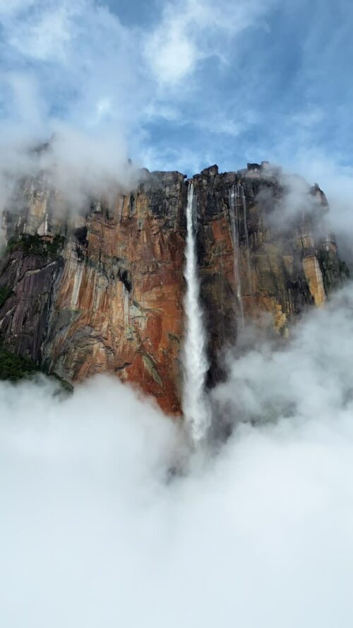Video - Aerial drone view of Angel Falls cascading from the Auyan tepui mountain in Canaima National Park, Venezuela, the tallest waterfall in the world. Vertical