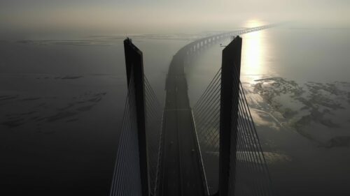 Video – Aerial drone view of Vasco da Gama bridge in Lisbon, Portugal, cinematic stock video - Starpik Stock