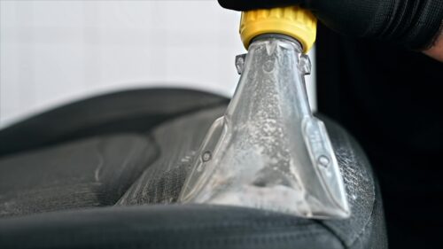 Video - Slow motion chemical cleaning of a car seat at a specialised service with vacuum mop foam
