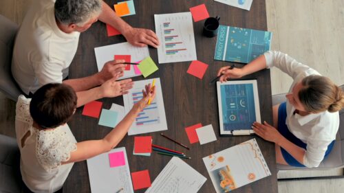 Video - Top view people at the office discussing business charts at a table
