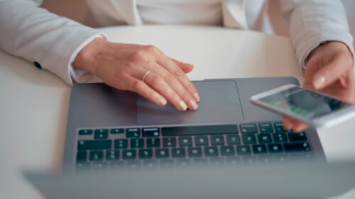 Video - Woman working on notebook and mobile phone