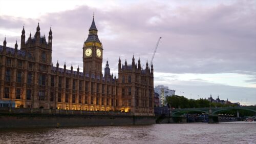 Video - View of London from a floating boat on the Thames River at sunset, United Kingdom. Westminster Palace and Elizabeth Tower