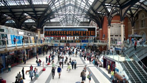 London, United Kingdom - September 14, 2023: Liverpool Street Station interior with multiple walking people, screens with trains info, shops